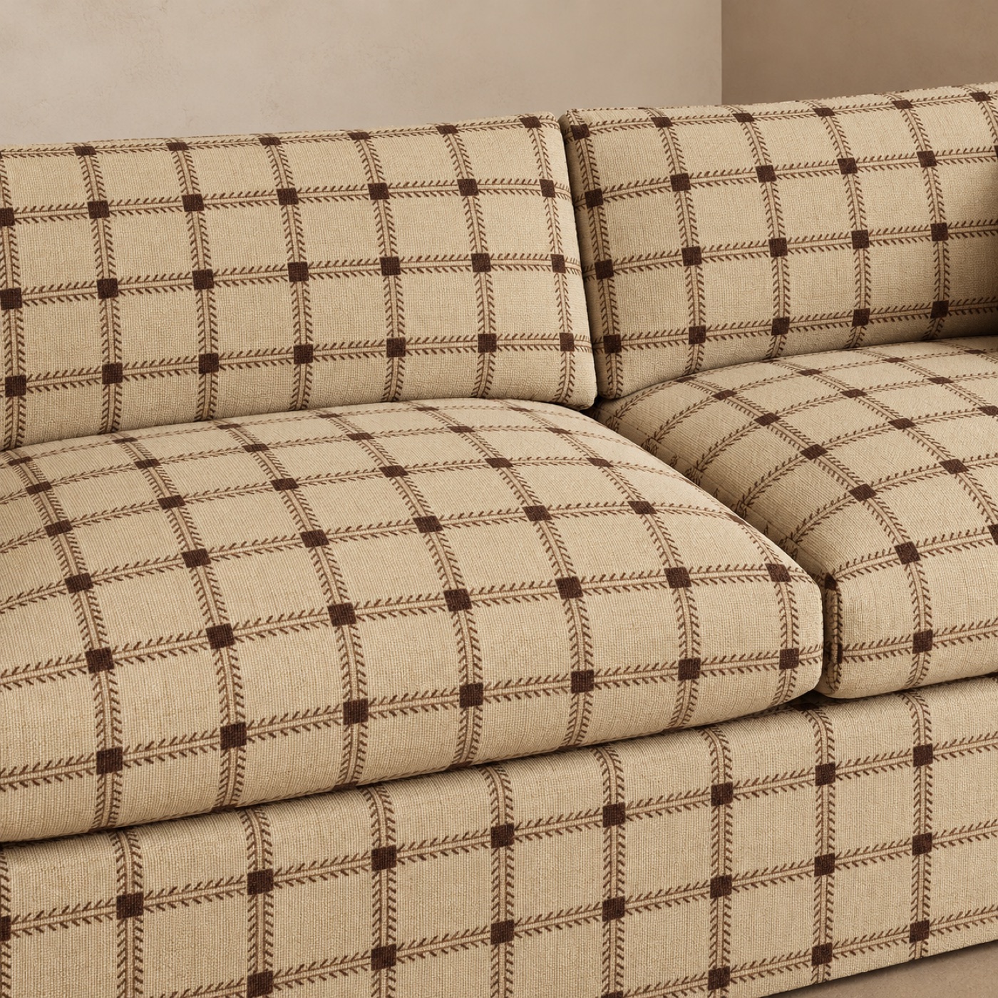 A deep sofa upholstered in a woven oatmeal and brown check fabric.